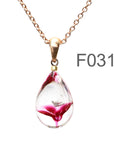 透明金赤色のお花が入った ガラスの遺骨ペンダント