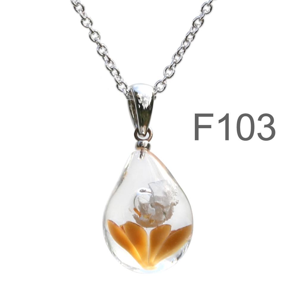 不透明薄茶色のお花が入った ガラスの遺骨ペンダント