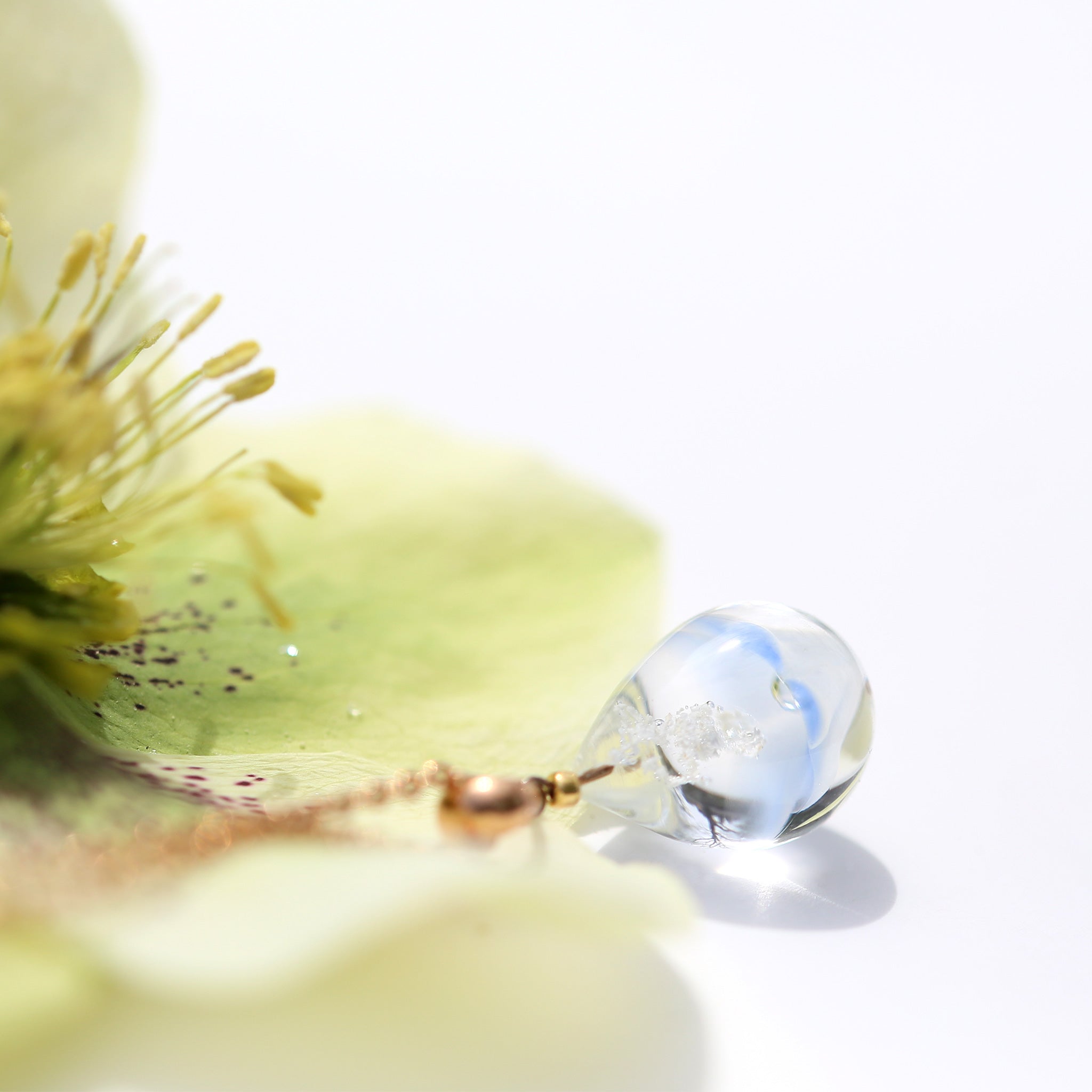 薄紺半透明白色のお花が入った　ガラスの遺骨ペンダント